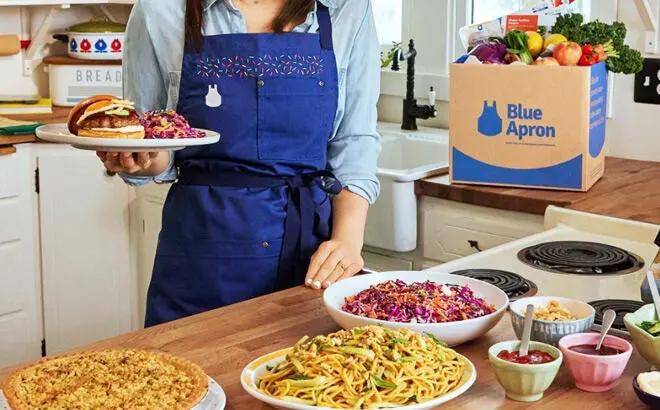 A Person Showing Several Meals That Were Prepared from a Blue Apron Meal