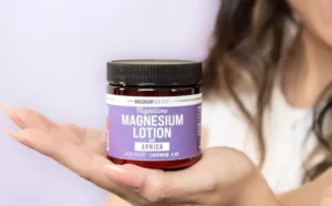 A Person Holding a Jar of Nighttime Magnesium Lotion