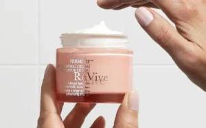 A Person Holding the ReVive Fermitif Neck Renewal Cream